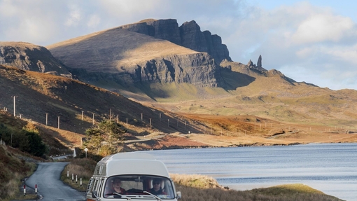 Wohnmobil auf einer Panoramastraße neben einem See