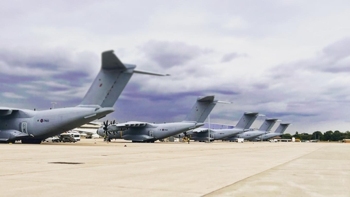 A row of military style aircraft on display at Brize Norton airfield in Oxfordshire