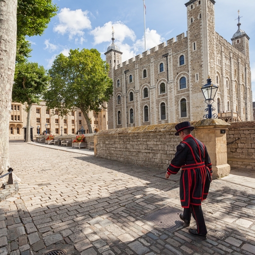 Beefeater walking by the, Tower of London on a sunny day