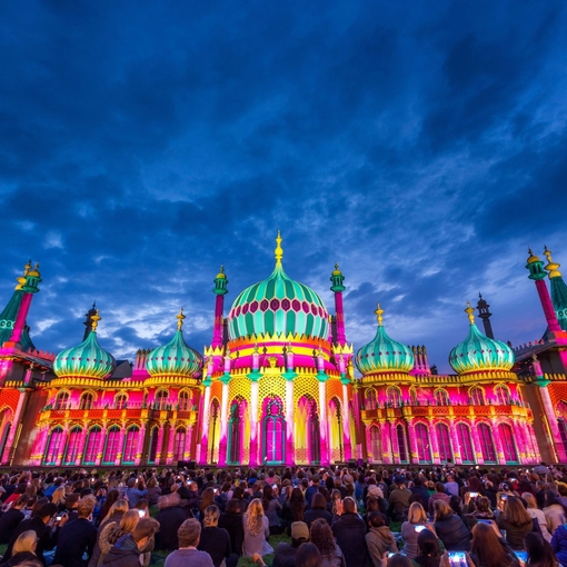 Royal Pavilion at dusk, lit up in a range of vivid colours
