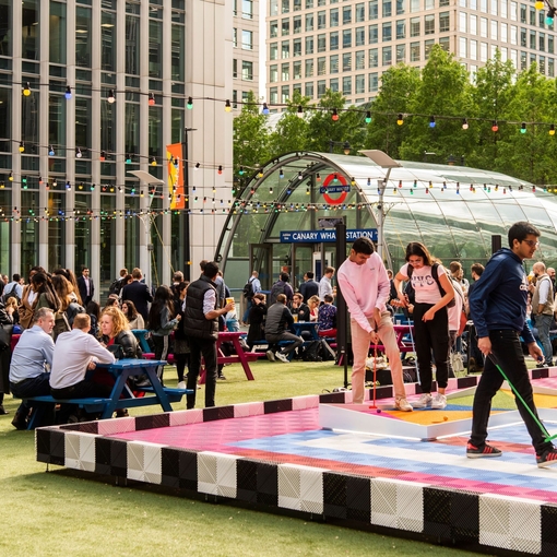 People playing mini golf at the Night Market in Canary Wharf