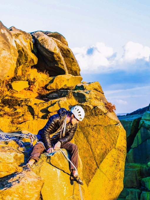 A rock climber considering a descent