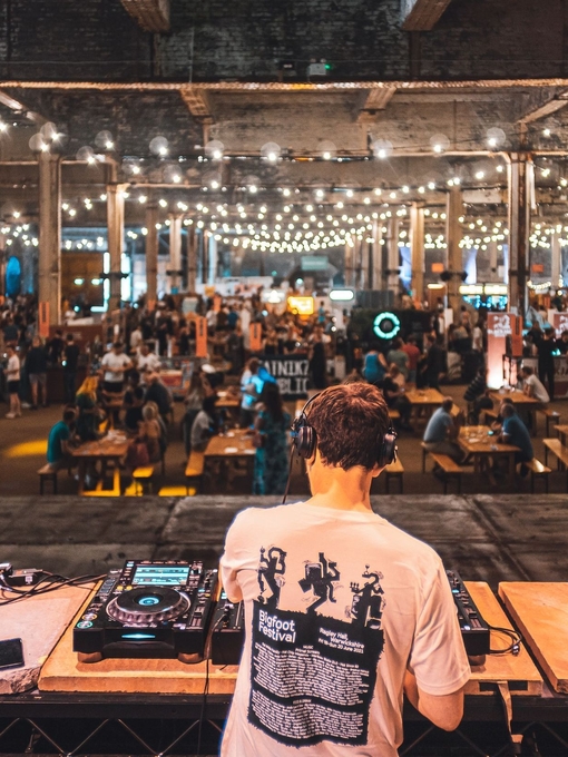 DJ playing to groups of people at Manchester Craft Beer Festival, in Depot Mayfield, Manchester