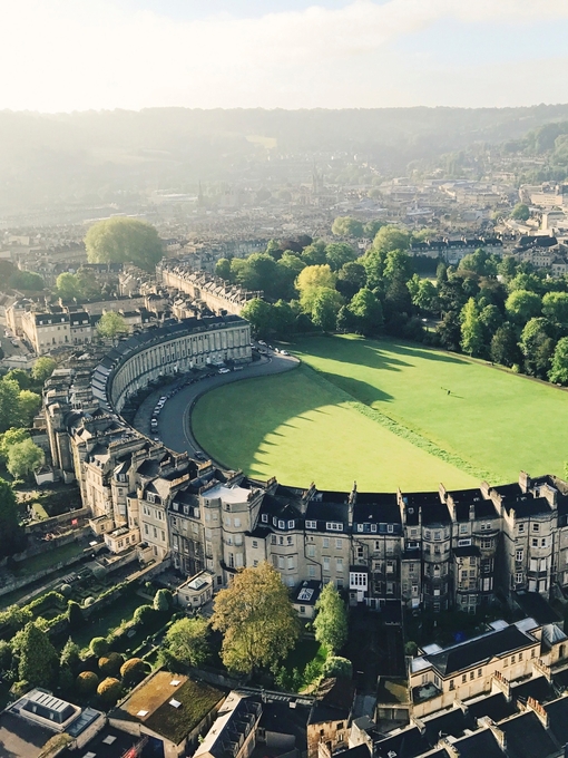Aerial view of crescent-shaped building surrounded by grass