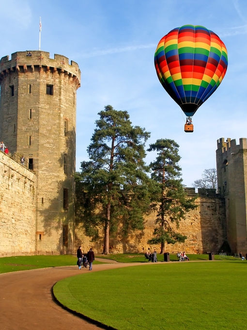 A hot air balloon floats over Warwick Castle in Warwickshire, England.