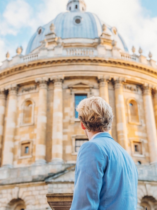 Man looking up at a historical building with dome