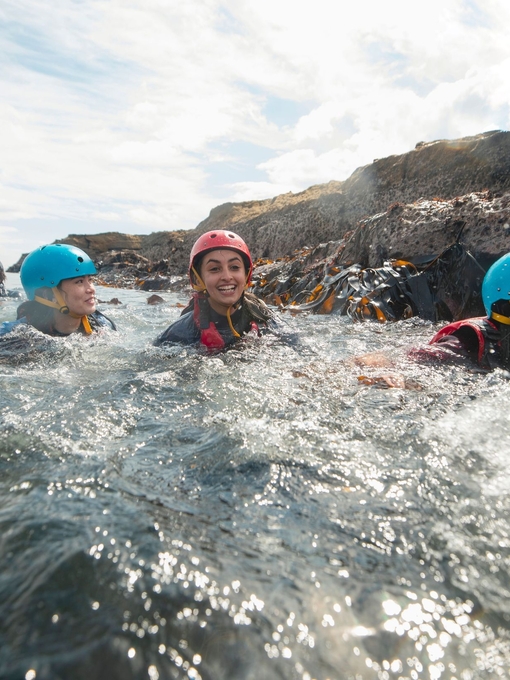 Teens coasteering in the North East of England at Beadnell.