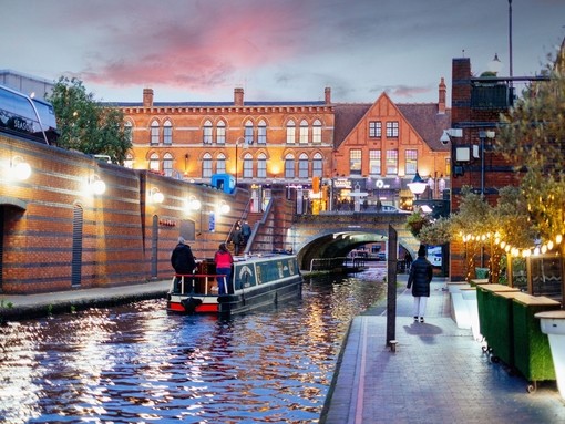 Riverboat on a canal. People walking down path