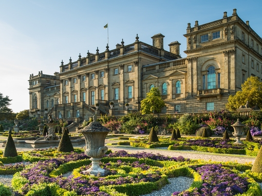 The Victorian formal gardens with statues and low hedges in front of Harewood House