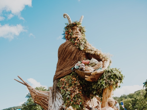 Group of people standing around large sculpture