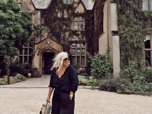 A woman stood outside The Pig Hotel in Combe, Devon