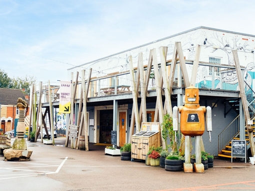 Robot sculpture outside a building with geometric décor