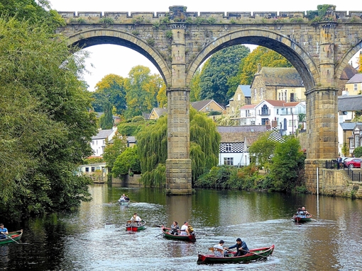 Boating along a river under a bridge with two arches