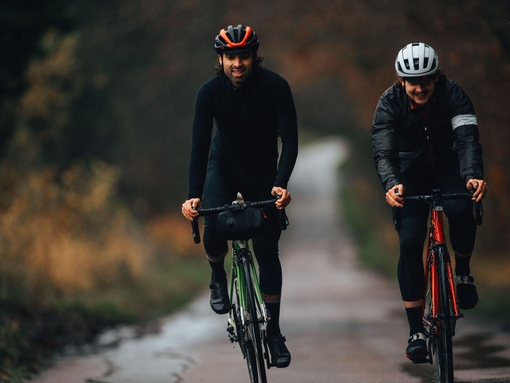 Two young cyclists riding in the Chiltern Hills during the winter.