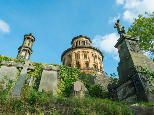 Old building with gravestones in foreground