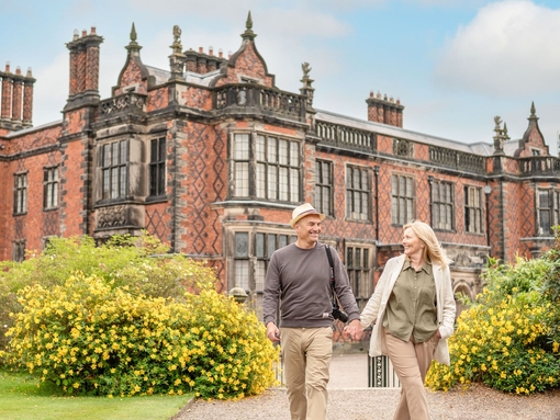 A man and a woman walk through the grounds of a heritage property