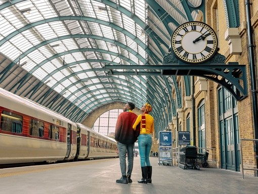 Man and woman gaze up at the ceiling at a train station