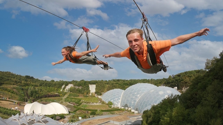 Two friends enjoying a zipline experience.