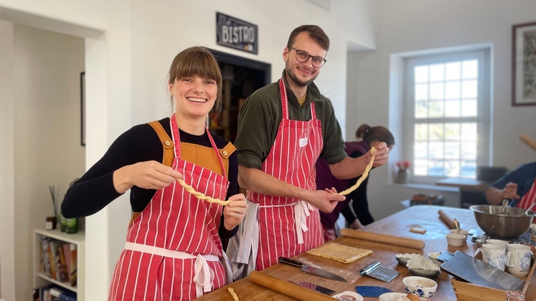 Two people taking part in a cooking experience