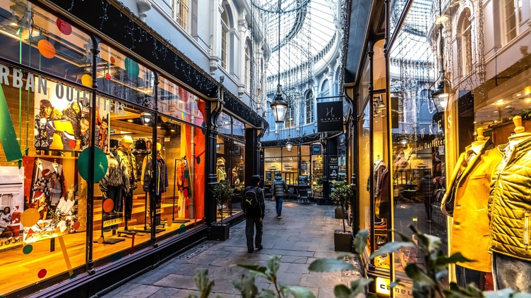 People walking between shops, lit up from inside