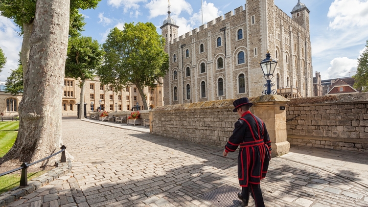 Beefeater walking by the, Tower of London on a sunny day