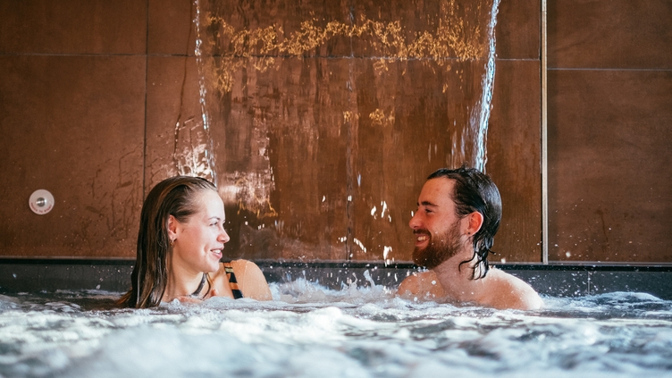 A couple in a pool as part of a spa treatment at Wave Garden Spa