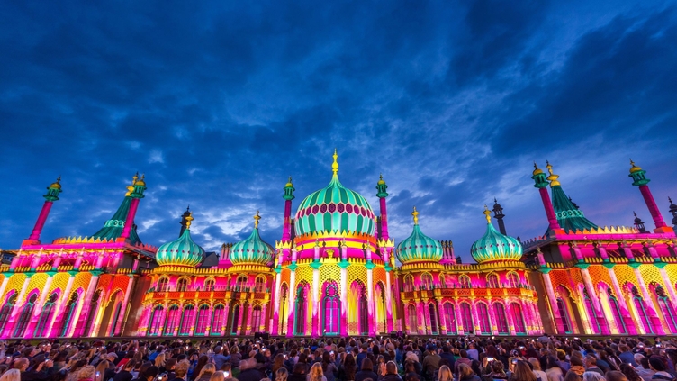 Royal Pavilion at dusk, lit up in a range of vivid colours
