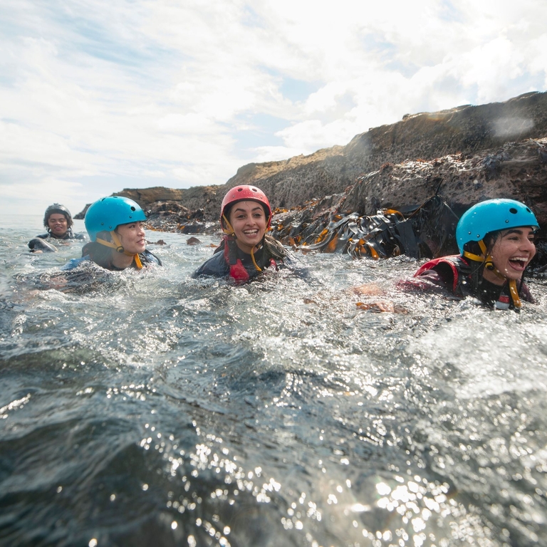 Teens coasteering in the North East of England at Beadnell.